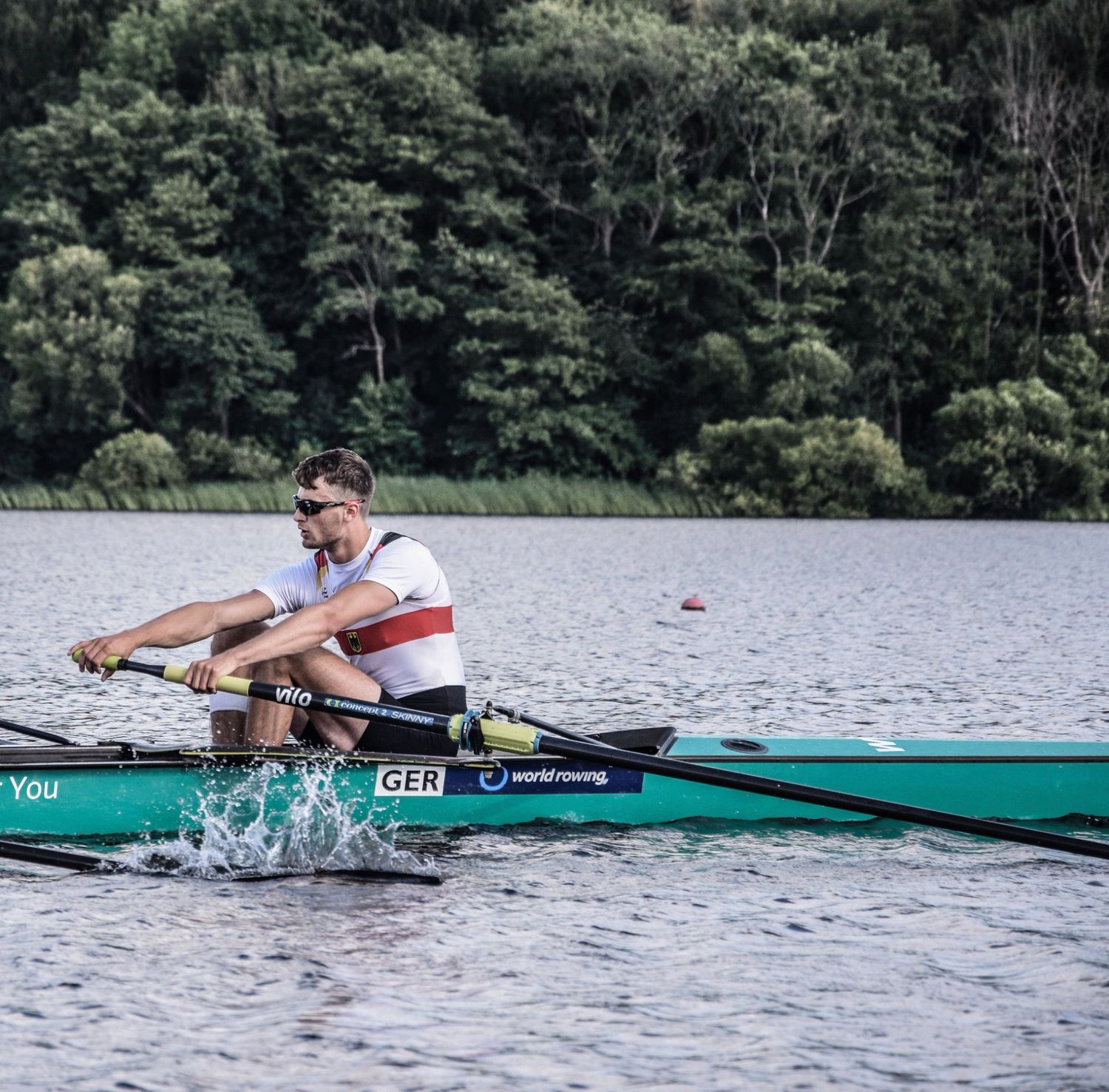 Robin rowing a single scull in the German national team kit